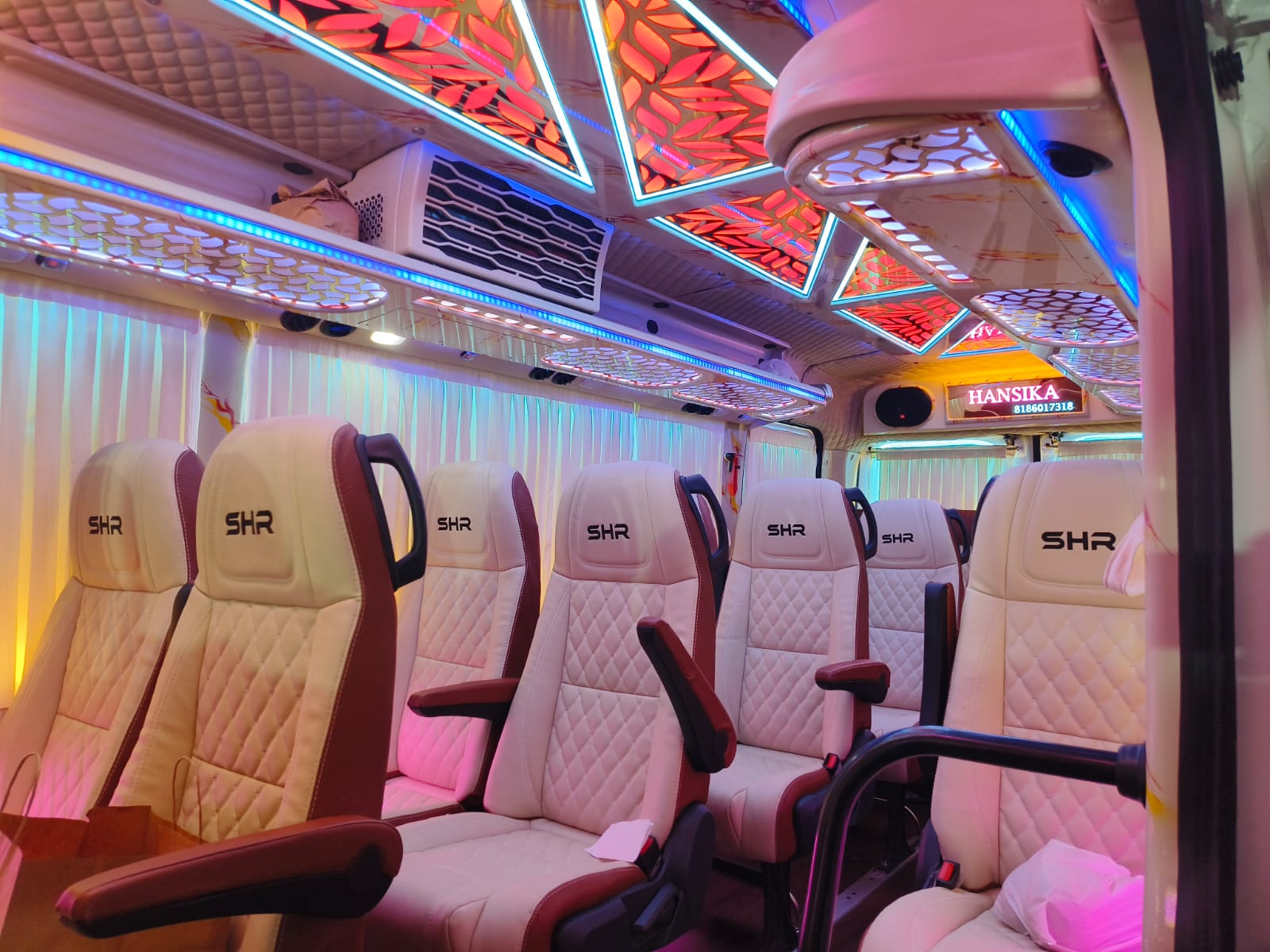 Wide view of premium bus seats with ceiling lights