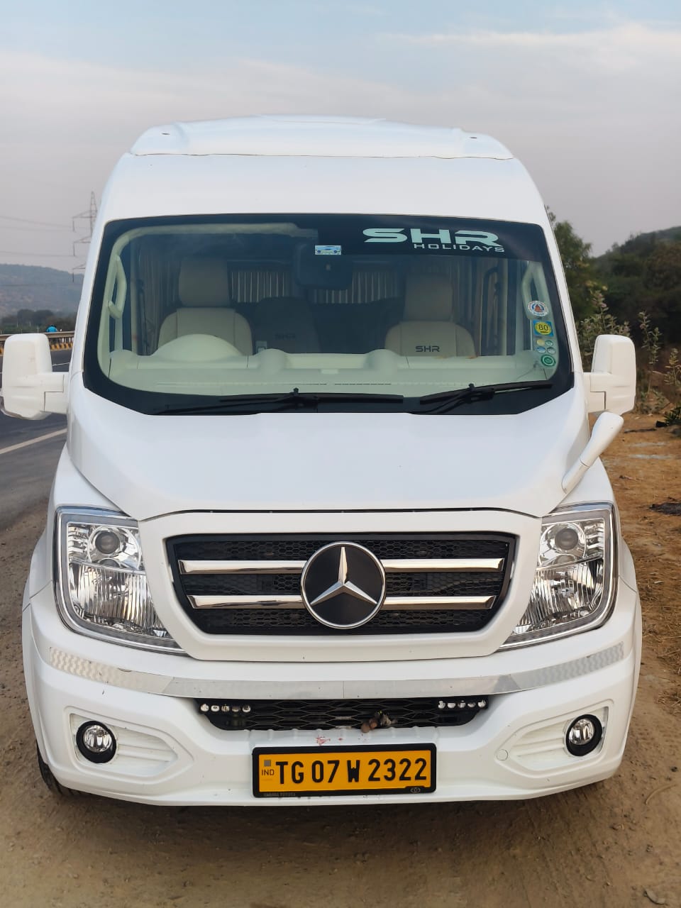 White Mercedes traveller vehicle front view
